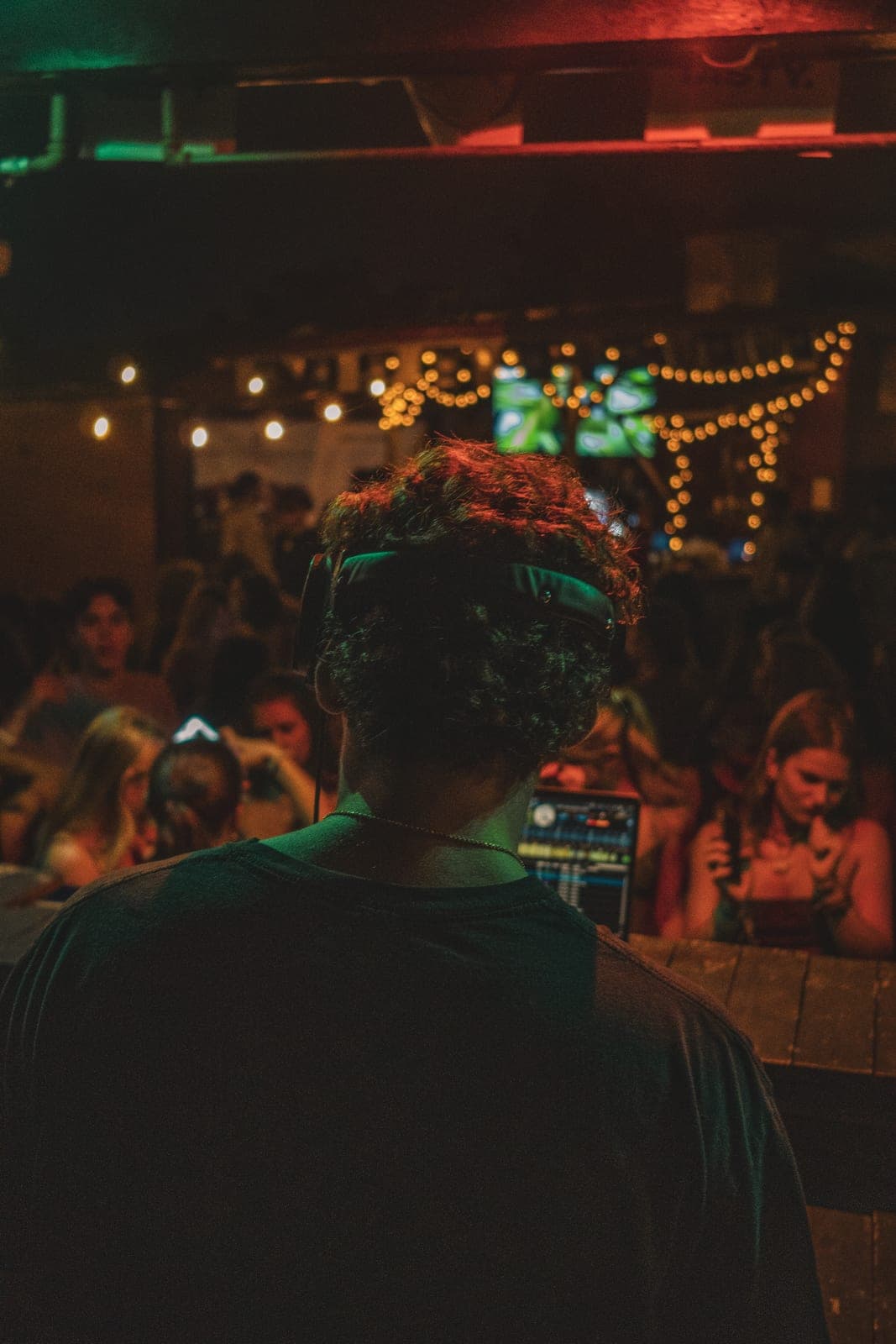 CAV mid-set, close on the decks under green and red bar lighting
