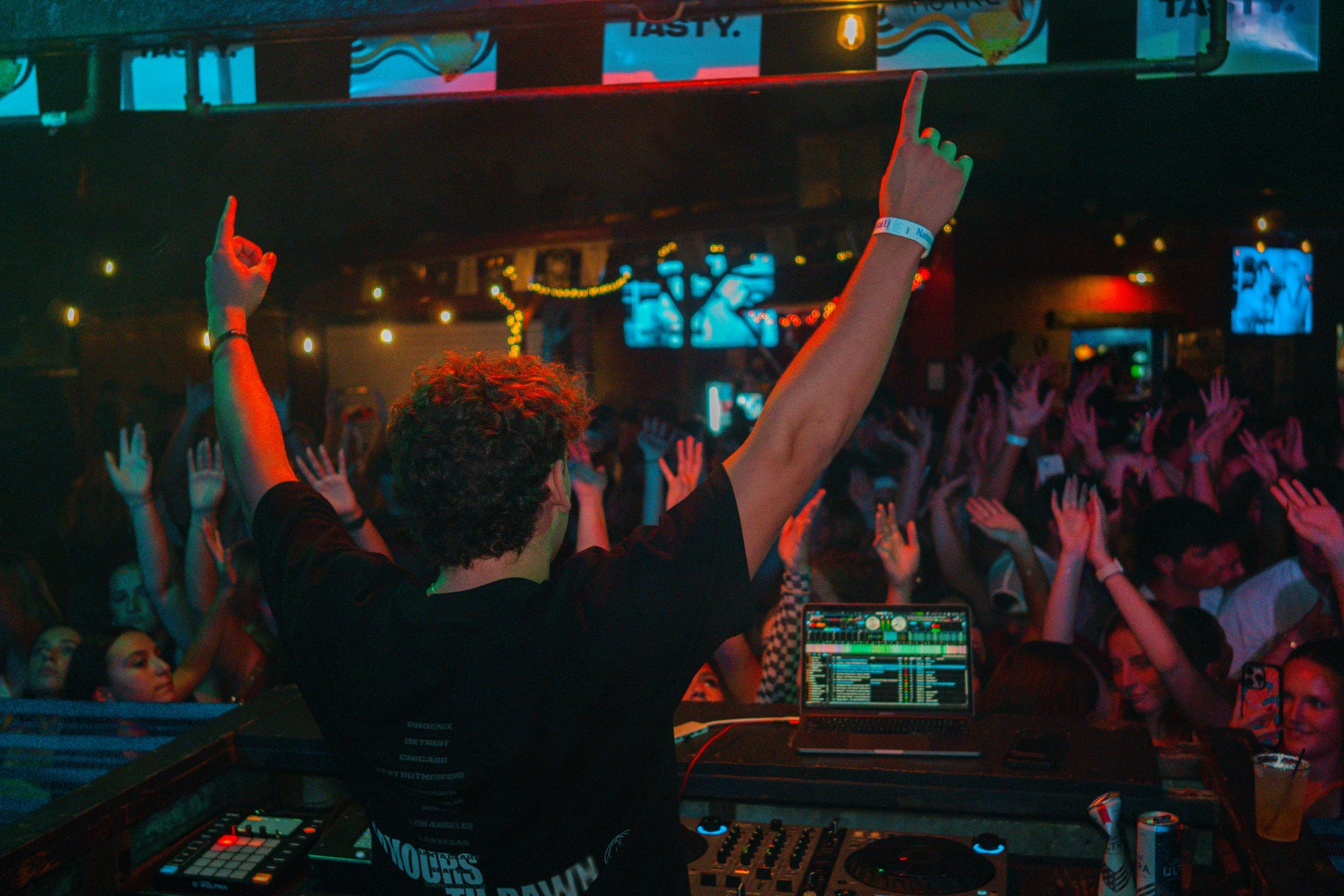 CAV, arms raised, facing a packed crowd mid-set